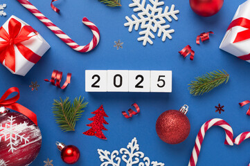 2025 with confetti and decor on color background, top view