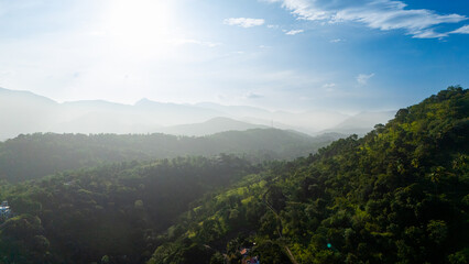 Lush green hills of Sri Lanka beneath a bright sky. Experience the stunning beauty of Sri Lanka's...