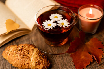 Autumn composition, tea, pumpkins, candle on the table. Autumn comfort at home
