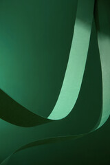 A subtle deep emerald backdrop contrasted with a delicate green ribbon that flows and swirls softly...