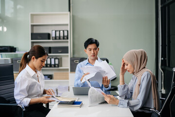 Furious team Asian businesspeople arguing strongly after making a mistake at work in office