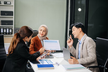 Office colleagues have a casual discussion. During a meeting in a conference room, a group of business teem