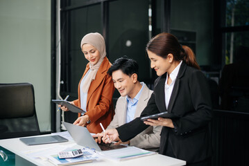 Office colleagues have a casual discussion. During a meeting in a conference room, a group of business teem