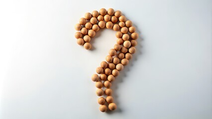 Explore creative ideas with a minimalist question mark design, utilizing small wooden balls to inspire thought-provoking concepts and engaging visual storytelling. Let creativity flow freely.