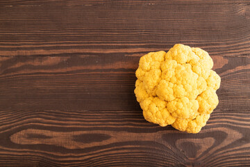 Yellow Cauliflower on brown wooden, Top view, copy space