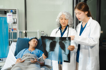 Doctor talking with man patient for monitoring and check up after surgery. doctor touching patient hand and consoling.