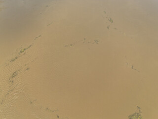 Mudflow of water in the Oder River of brown color. Poland. View from above. Background.