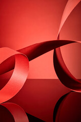 To give the picture a feeling of movement and to create empty zones for products and information that might be displayed, the red paper strips are stretched and curved into circular arcs.