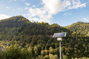 Solar Panel On High Metal Pole With High Mountain Forests Background