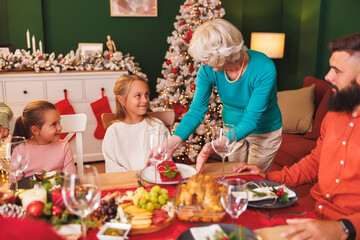 Senior woman setting the table for family Christmas dinner