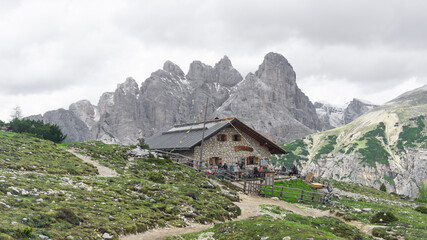 Stone and beautiful alpine refugee on a cloudy day with the mountains in the background