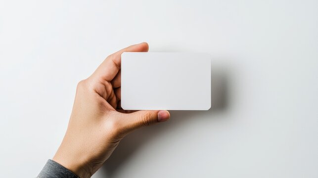 Hand presenting a blank card, clean white background, ideal for customizable business cards, contact information designs, or promotional material mockups