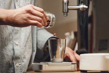 Barista Precisely Measures Coffee Beans on Scales for Optimal Grind and Flavor Close-up