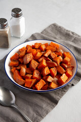 Homemade Roasted Sweet Potatoes on a Plate, side view. Close-up.