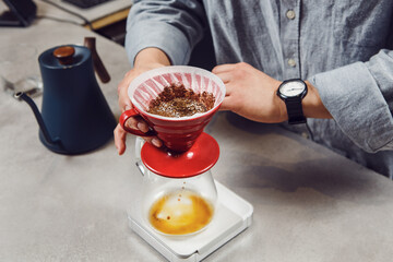 Expertly Brewing Single Cup of Pour-Over Coffee in Modern Cafe Setting