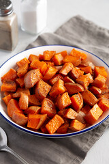 Homemade Roasted Sweet Potatoes on a Plate, side view. Close-up.