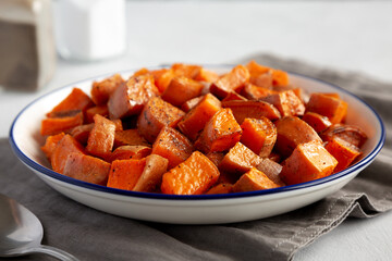 Homemade Roasted Sweet Potatoes on a Plate, side view. Close-up.