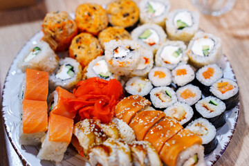 A large plate with an assortment of rolls.