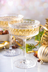 Two champagne glass on Christmas decorated background