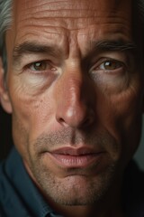Fototapeta premium Close-up Portrait of Mature Man with Intense Gaze, Detailed Facial Features and Wrinkles, Realistic Male Expression, Aging and Experience