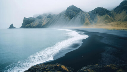 Misty Mountains and Black Sand Beach in Serene Coastal Landscape