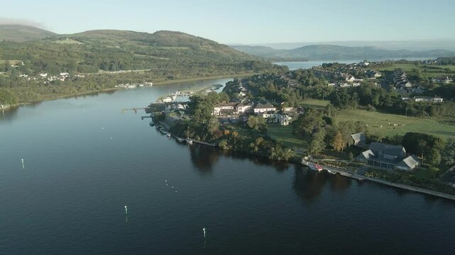 Killaloe town along a peaceful river with lush hills in county limerick, ireland, aerial view