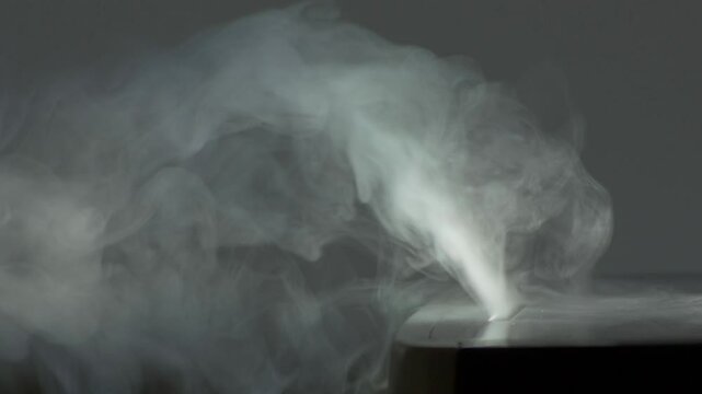 Humidifier provides healthy humidity levels in living room. Steam of fine mist dispersing into air from ultrasonic humidifier. Health care concept slow motion video