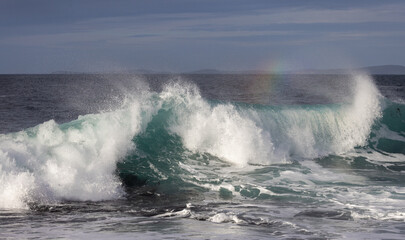 Wave breaking with Rainbow, Orkney, Scotland
