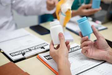 Businessman shaking hands with doctor in conference room Doctor and pharmacist shaking hands in medical office Salesman with new medicines shaking hands in hospital with medical team