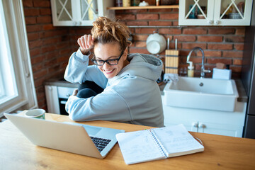Young woman working from home on laptop