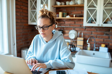 Young woman working from home on laptop