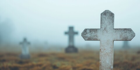 A misty graveyard with crosses shrouded in fog, evoking a sense of mystery and contemplation in a serene setting.