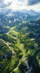 Fototapeta premium Breathtaking aerial view of a lush green valley surrounded by majestic mountains under a blue sky with soft clouds.