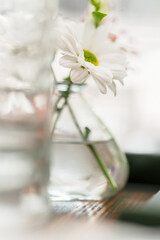 White flowers in a vase at a restaurant.