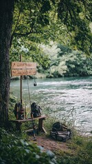 Naklejka premium Tranquil setting by a river with backpacks and chairs, perfect for relaxation and outdoor adventures amidst nature's beauty.