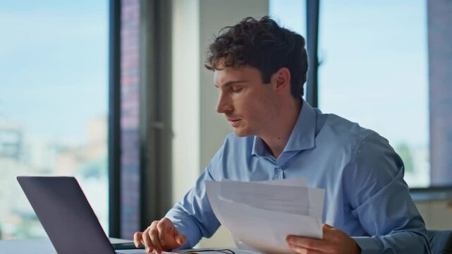 Mad manager throwing documents looking at laptop in remote office closeup.