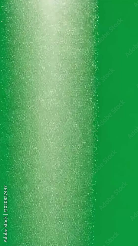 Poster white particles fall gracefully against a vibrant green screen, creating a captivating visual effect