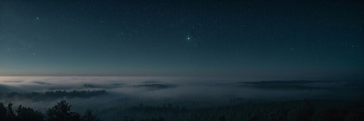 Fototapeta premium A foggy night sky with a few stars. The sky is dark and the stars are visible