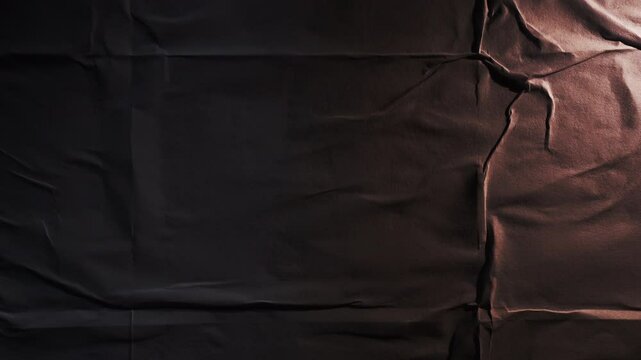 Abstract black wheatpaste paper poster texture background with moving light