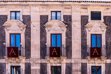 window with red banner or pennant with letter A for decotarion of old building facade