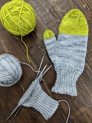 Knitting mittens on double pointed needles.