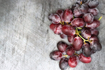Grapes on a grey background, top view, copy space. Healthy eating concept. 