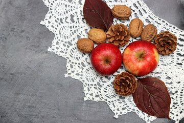 Autumn composition with fruit and leaves on grey background, top view. Healthy eating concept. 