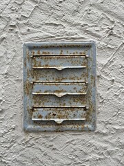Old rusted mailboxes bricked into an old plastered wall