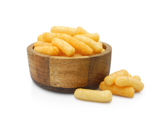Corn puffs in wooden bowl, crunchy snack isolated on white background