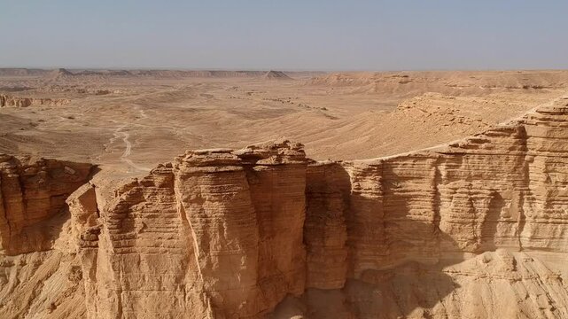 Camera drone flies backwards over Edge of the World, a popular tourist destination near Riyadh