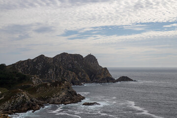 Image Description: Dramatic coastal landscape with rugged cliffs, crashing waves, and a cloudy sky. Perfect for projects related to nature, travel, or adventure.