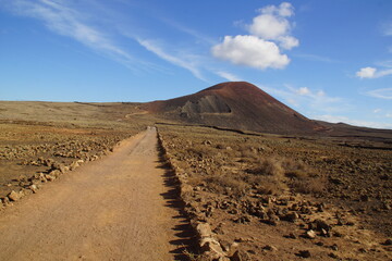 desertic landscape of volcano and caldera on the sea side