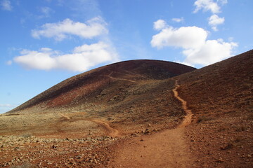 desertic landscape of volcano and caldera on the sea side