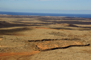 desertic landscape of volcano and caldera on the sea side